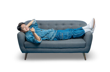 A happy young man relaxes on the couch and makes a small finger heart gesture, showing love and...