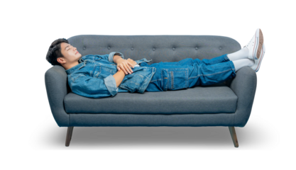 A tired young man sleeps on a sofa, taking a nap to recharge. Isolated on a png  background.
