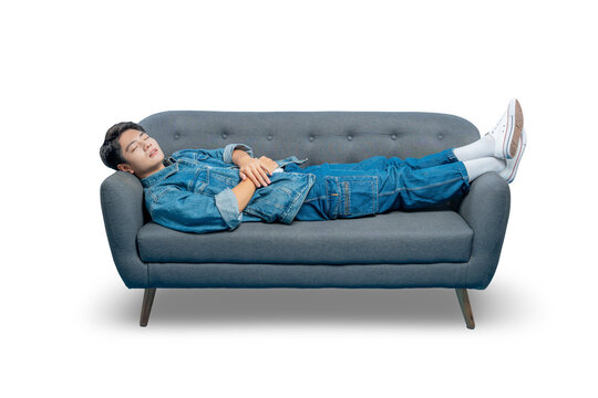 Asian man in casual clothes is sleeping peacefully while lying on a sofa, representing rest and relaxation.PNG