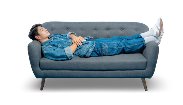 A tired young man sleeps on a sofa, taking a nap to recharge. Isolated on a png  background.
