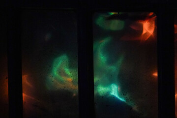Green and a bit orange flames in a fireplace making abstract patterns