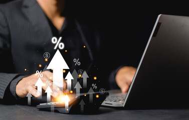 Interest rate concept. Businessman using calculator with percentage graph symbol and up arrow....