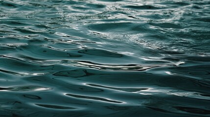 The tranquil surface of rippling water reflecting soft light and shadows.