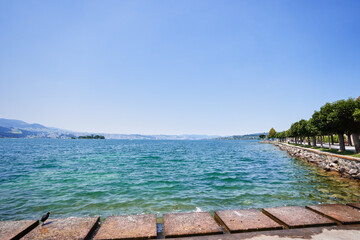 Beautiful Scenic View of a Lakeside Promenade on a Clear Sunny Day