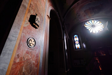 Historic Church Interior Featuring Stained Glass Windows and Sacred Artistic Elements