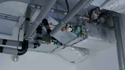 Ventilation system with ductwork and pipes, showcasing intricate design and functionality, highlighting air circulation and environmental control in modern architecture