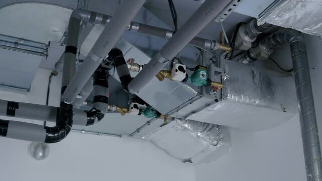 Ventilation system with ductwork and pipes, showcasing intricate design and functionality, highlighting air circulation and environmental control in modern architecture