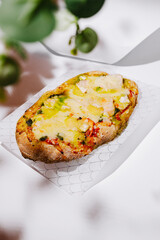 Delicious flatbread topped with cheese and fresh ingredients in a cozy setting