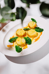 Gourmet Vegetable Medallions with Creamy Sauce and Spinach Leaves