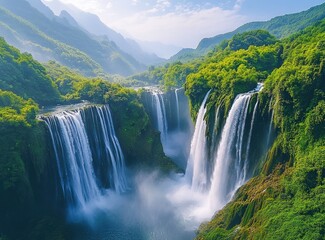 Waterfalls cascade through lush, misty green mountains