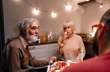 A cozy dinner setting in a warmly lit kitchen with a family enjoying conversation and food, creating a serene and engaging atmosphere perfect for cherished moments.