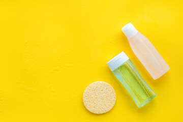 mycelial water, lotion and sponge for skin care on yellow background flat lay space for text