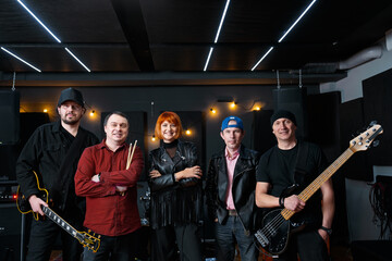 Energetic Rock Band Group Performing in Music Studio Setting