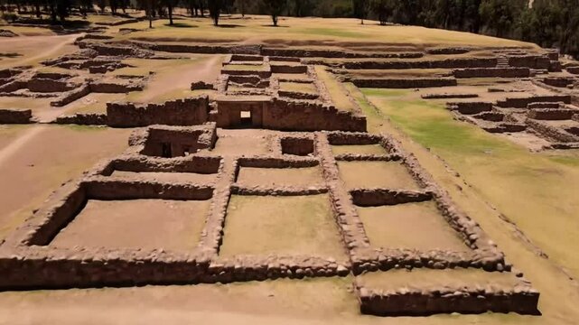 Aerial view of ancient archaeological site with stone ruins and walls on a sunny day, showcasing the inca civilizations historical architecture