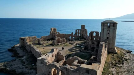 An aerial view of the aragonese castle, a medieval fortress and ruins on an island off the coast of le castella, calabria, italy