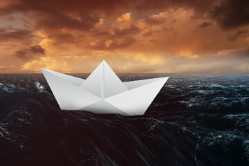 Paper boat floating on the sea