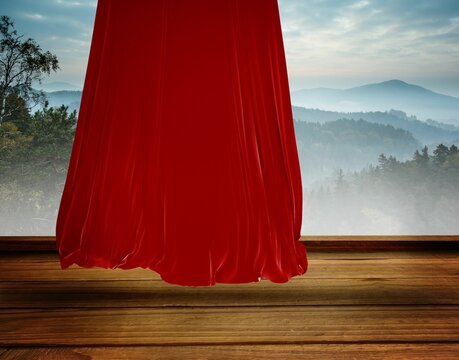 Fototapeta Flat design showing red velvet curtain unfolding on wooden stage amid misty hills and distant peaks