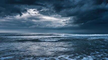 The turbulent ocean under a dramatic stormy sky at dusk.