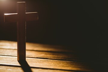 Wooden cross on brown hardwood floor