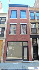 Obraz premium Renovated brick storefront building in urban setting. Potential for commercial use