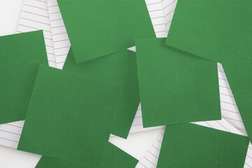 Green paper strewn over notepad
