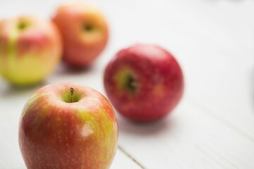 Fresh red apples on wooden table