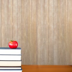 Red apple on pile of books