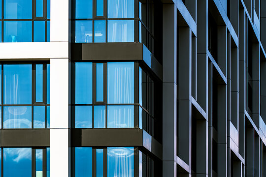 Glass facade with diagonal pattern of reflective blue windows and vertical architectural elements