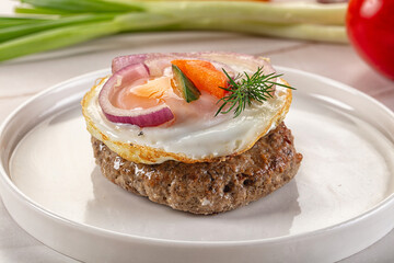 Beefsteak chop with roasted egg