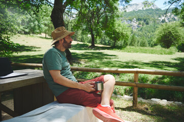 Man Relaxing in a Scenic Mountain Setting, Enjoying a Summer Day Outdoors