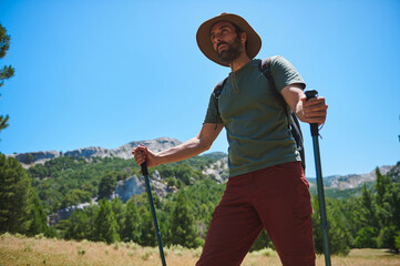Mountain Trekking Adventure of Bearded Man with Backpack Under Sunny Skies