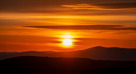 Obraz premium Fiery Sunset Over Mountain Ridges with Dramatic Orange and Red Hues