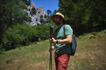 Man Hiking on a Sunny Summer Day in Mountainous Terrain