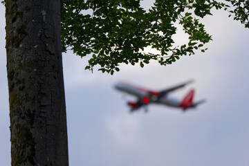 Final approach of defocused passenger airplane at Swiss city of Zürich on a spring morning. Photo...