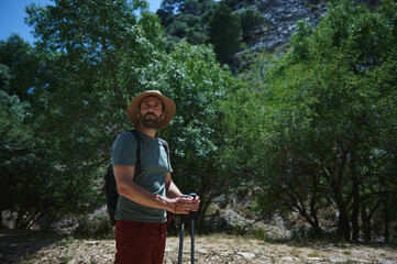 Adventure Traveler Hiking Through Mountain Trails on a Warm Summer Day