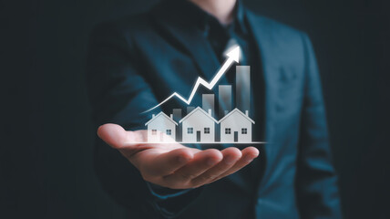 A professional business photo showing a person in a dark business suit holding a holographic real estate graphic in their palm