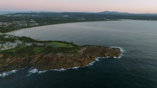 Aerial: Drone shot of Tathra headland early morning before the sun rises, South Coast NSW, Australia