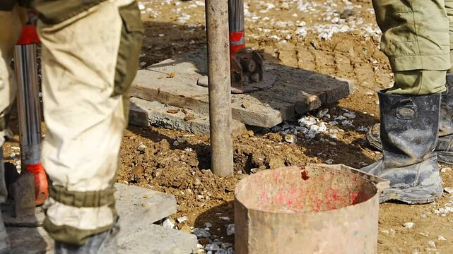 Close-up of soil sampling during pile drilling process. Extraction of subsurface material for geotechnical analysis and foundation assessment