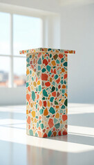 Colorful terrazzo pedestal with geometric fragments