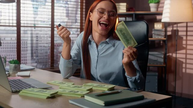 Excited Caucasian businesswoman burning money with fire in office happy business woman female rich financial madness risky emotional spending wealth reckless investment crisis economic loss finance