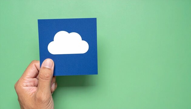A hand holding a square blue paper with a cloud icon on green background