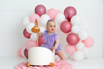 happy baby girl on pink and white balloons background