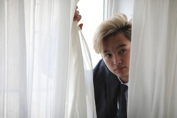 Young Asian businessman in white shirt and tie