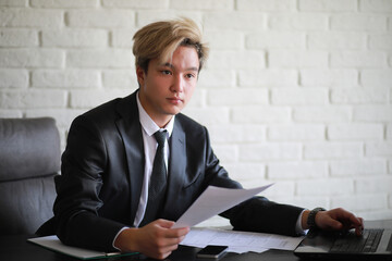 Young Asian businessman in white shirt and tie