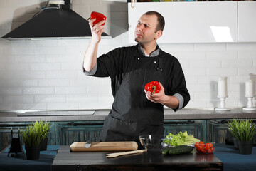 Man cook preparing food at the kitchen of vegetables