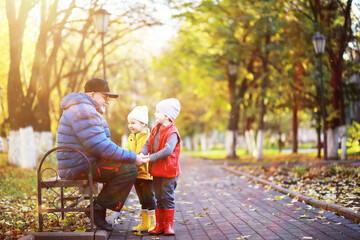 Children walk in the autumn park