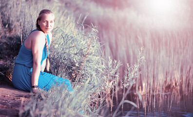 Pregnant girl in a field with flowers