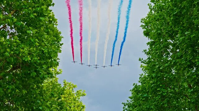 Planes with colored smoke. The colors of the French flag in the sky over Paris