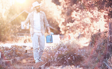 Man farmer watering a vegetable garden
