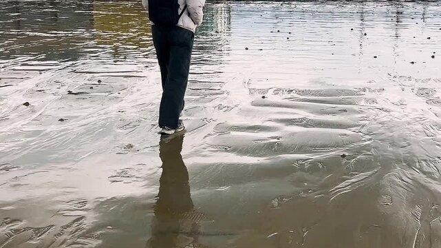 Walking on wet sandy beach on the English Channel at low tide in Saint-Malo. Grande Plage du Sillon. Saint-Malo, Ille-et-Vilaine, Brittany, France.